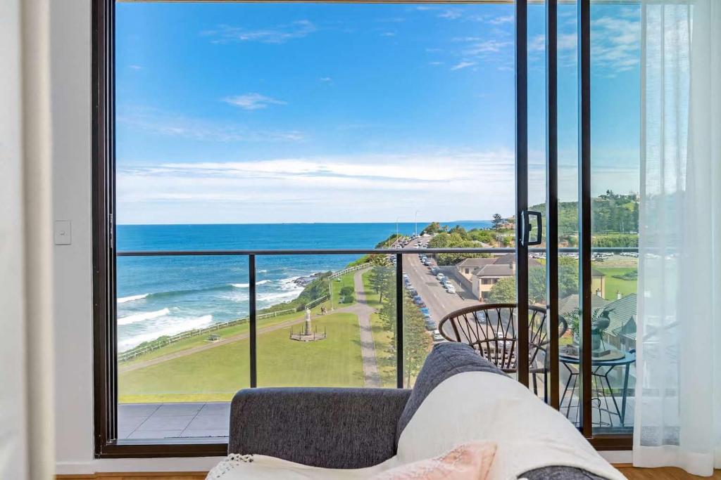 a living room with a couch and a view of the ocean at 901 - Perfect Penthouse - With Free Parking in Newcastle