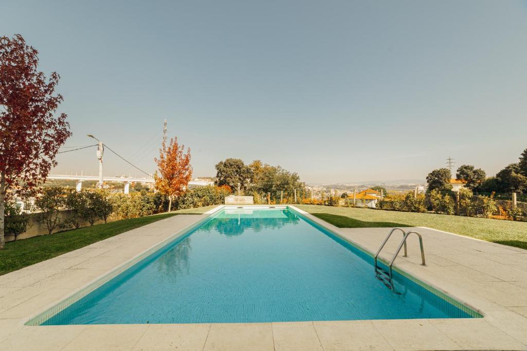 a swimming pool in the middle of a yard at Amazing Pool Apartments by Vacationy in Vila Nova de Gaia