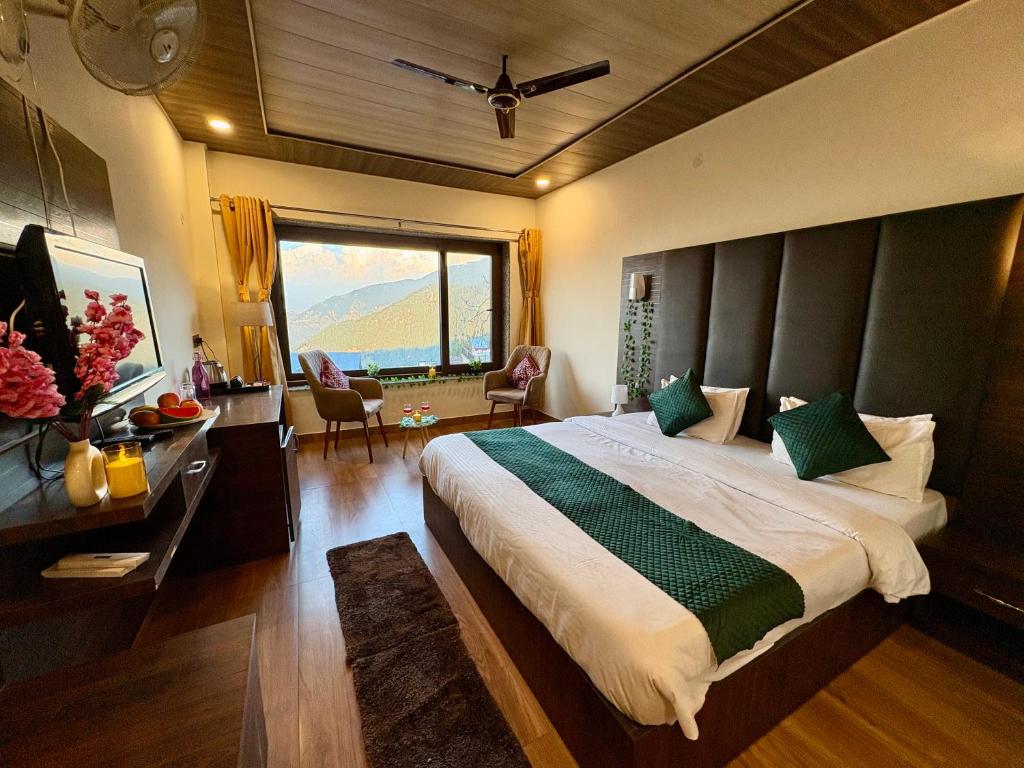 a bedroom with a large bed and a large window at The Zen Villa in Dalhousie