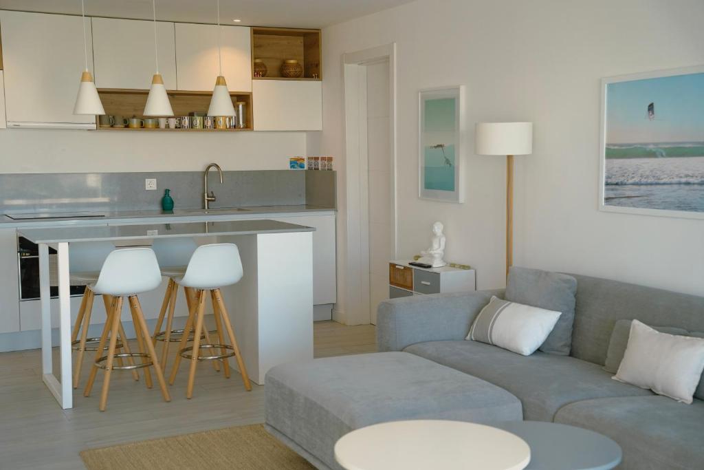 a living room with a couch and a kitchen at Sunset House Fuerteventura in Villaverde