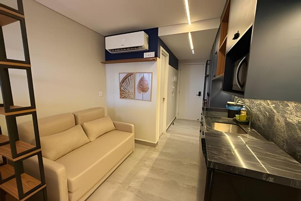 a living room with a couch and a tv at 403 Ocean Art Park - Take Home in Tambaú