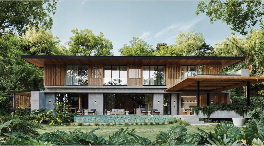 a house in the middle of a garden at Casa Nunc - New Home - 3 Minute Walk to the Beach in Nosara