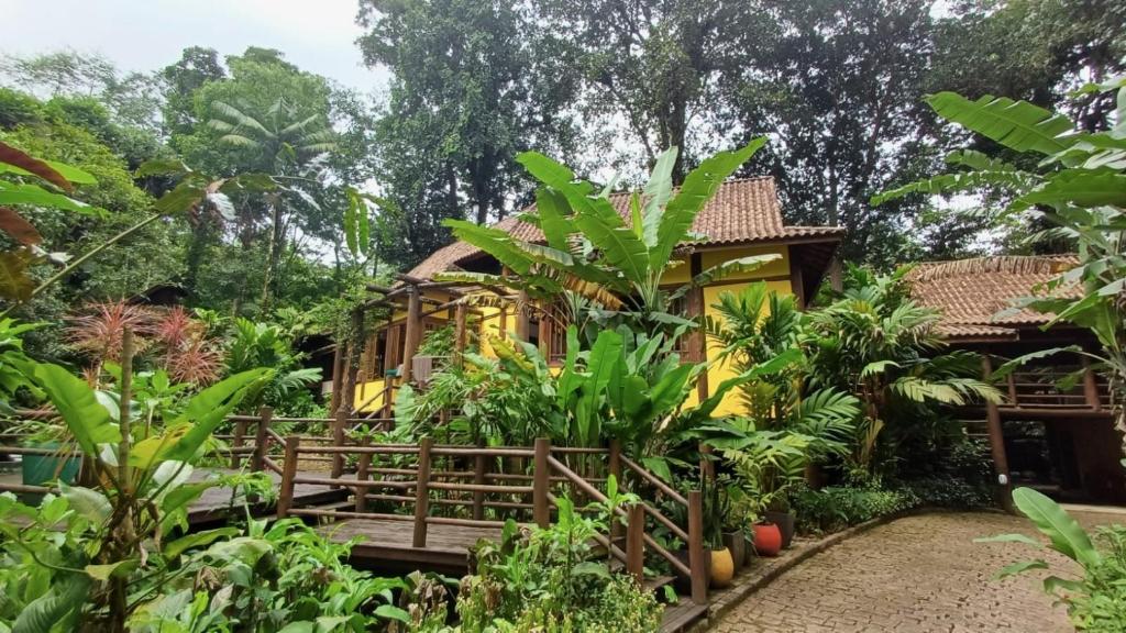 a house in the middle of a garden at Casa Sertão de Camburi in Camburi