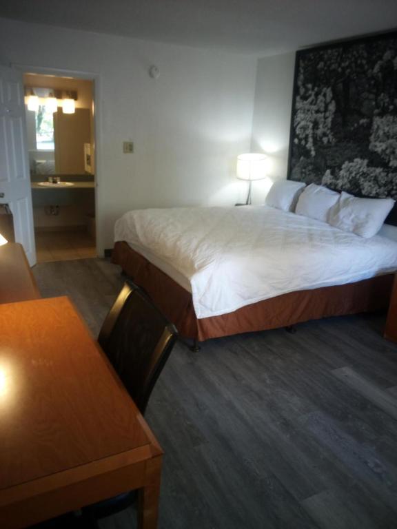 a hotel room with a large bed and a table at MHO Hotel Dover in Dover