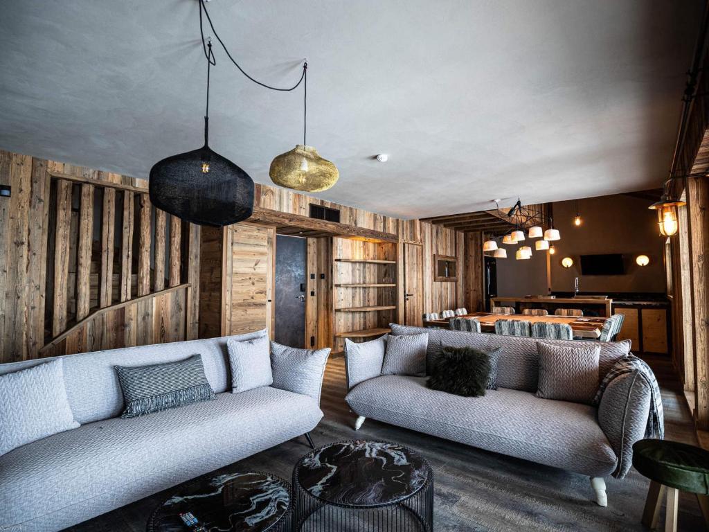 a living room with two couches and a table at Chalet Méribel 12 pers, 5 ch, Animaux Admis, Parking - FR-1-566-83 in Chandon