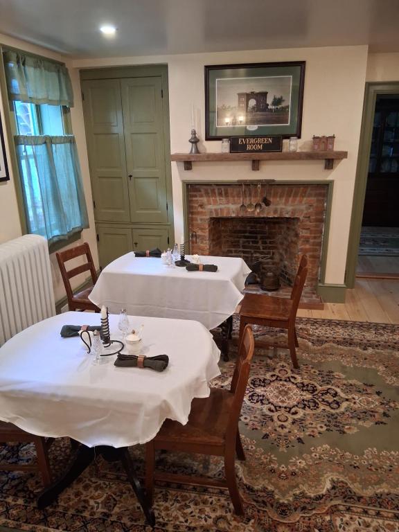 a dining room with two tables and a fireplace at Langdon Hill House Langdon Room in Gettysburg