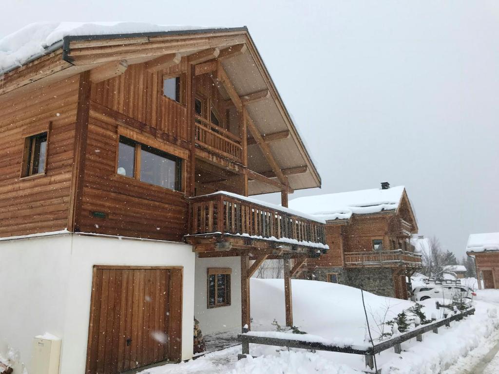 a log cabin in the snow with a porch at Cozy Chalet With Scenic View In Monêtier Les Bains in Le Monêtier-les-Bains