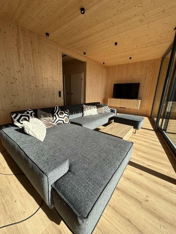 a room with three beds and a flat screen tv at Ferienhaus Mayka in Hochrindl