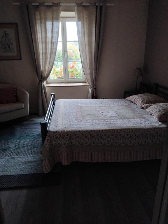 une chambre avec un lit et une fenêtre dans l'établissement Le gîte de Christine, à Lagarde