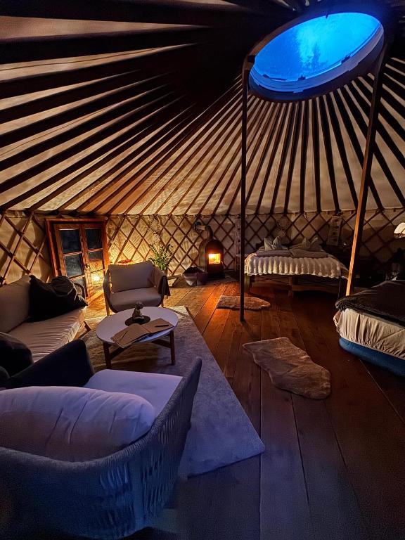 a room with a yurt with couches and a table at Jurte in den Bergen in Bad Reichenhall