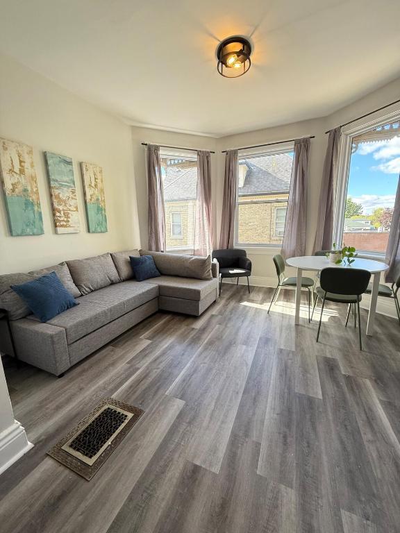 a living room with a couch and a table at Second Floor Apartment in Victorian House in Strathroy