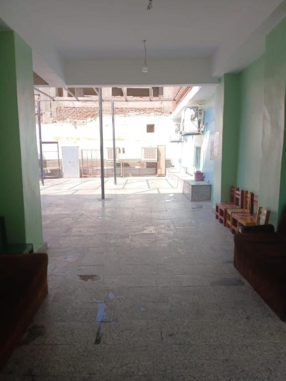 an empty room with green walls and a large window at Lavande Nubian House in Aswan