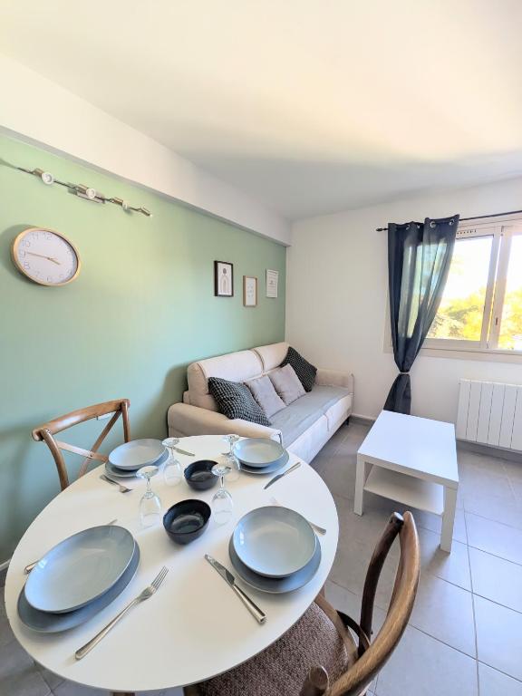 a living room with a table and a couch at Charmant T2 150 m de la cure thermale Gorges Du Verdon in Gréoux-les-Bains