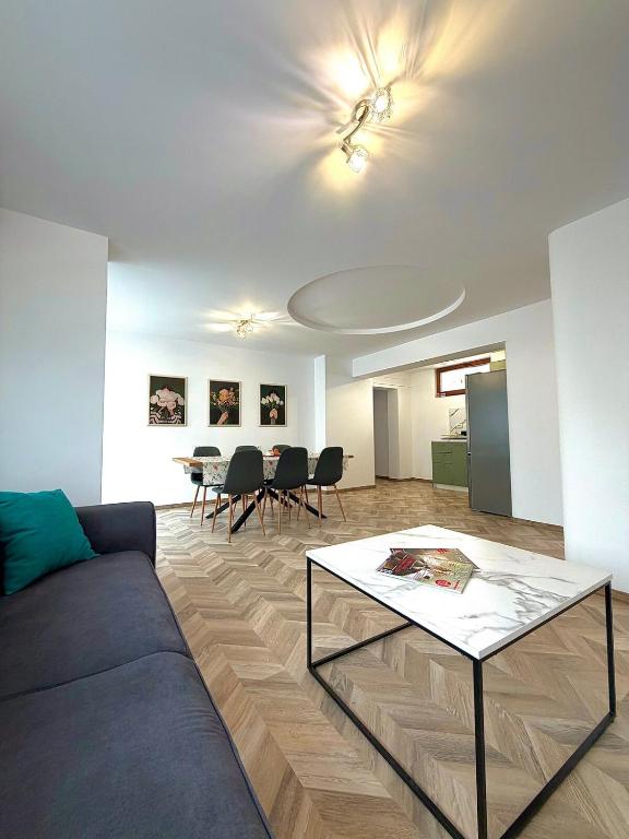 a living room with a couch and a table at Apartment Draganovi 8A in Kazanlŭk