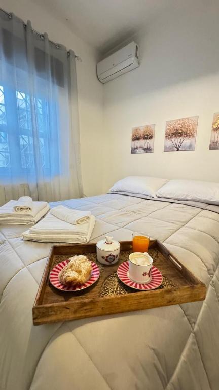 a bed with a tray of food on it at Riva in Pozzuoli
