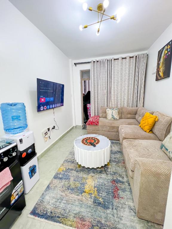a living room with a couch and a table at Ellber Homes in Nairobi