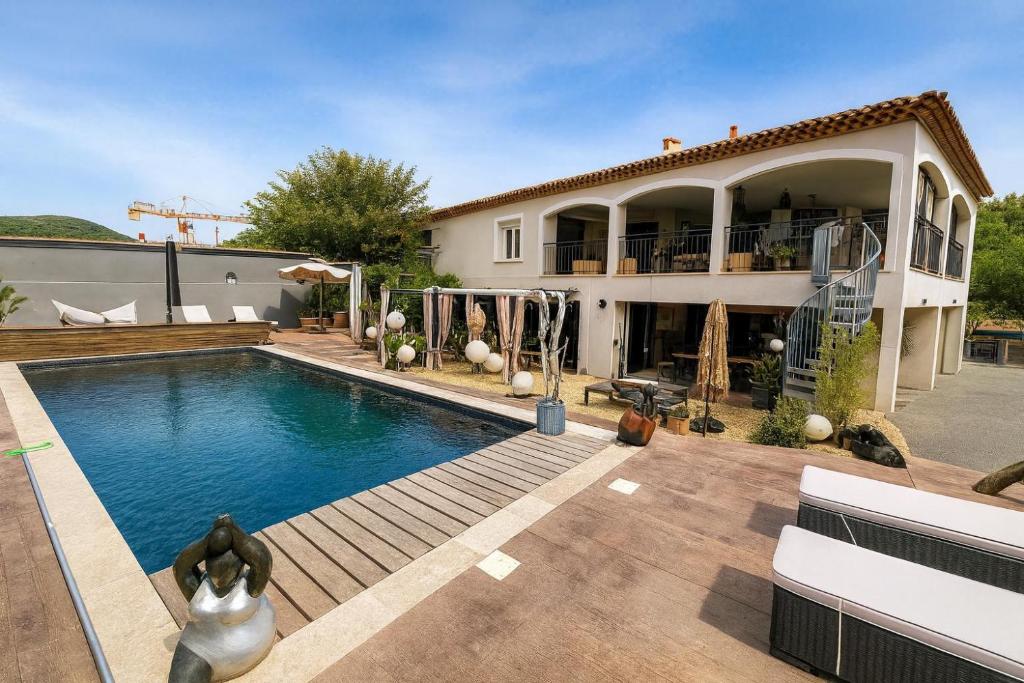 a house with a swimming pool in front of a house at il était une fois in Flassans-sur-Issole