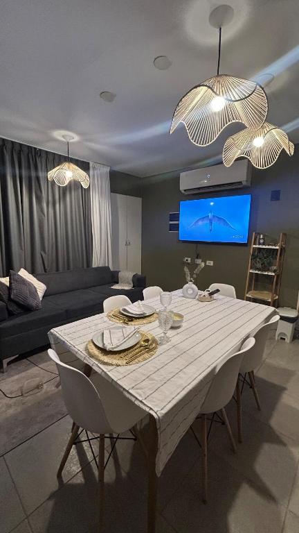 a living room with a table with chairs and a couch at Eliseo Chalet in Yerba Buena