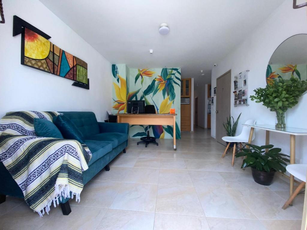 a living room with a blue couch and a table at Casa Borbon in Salento