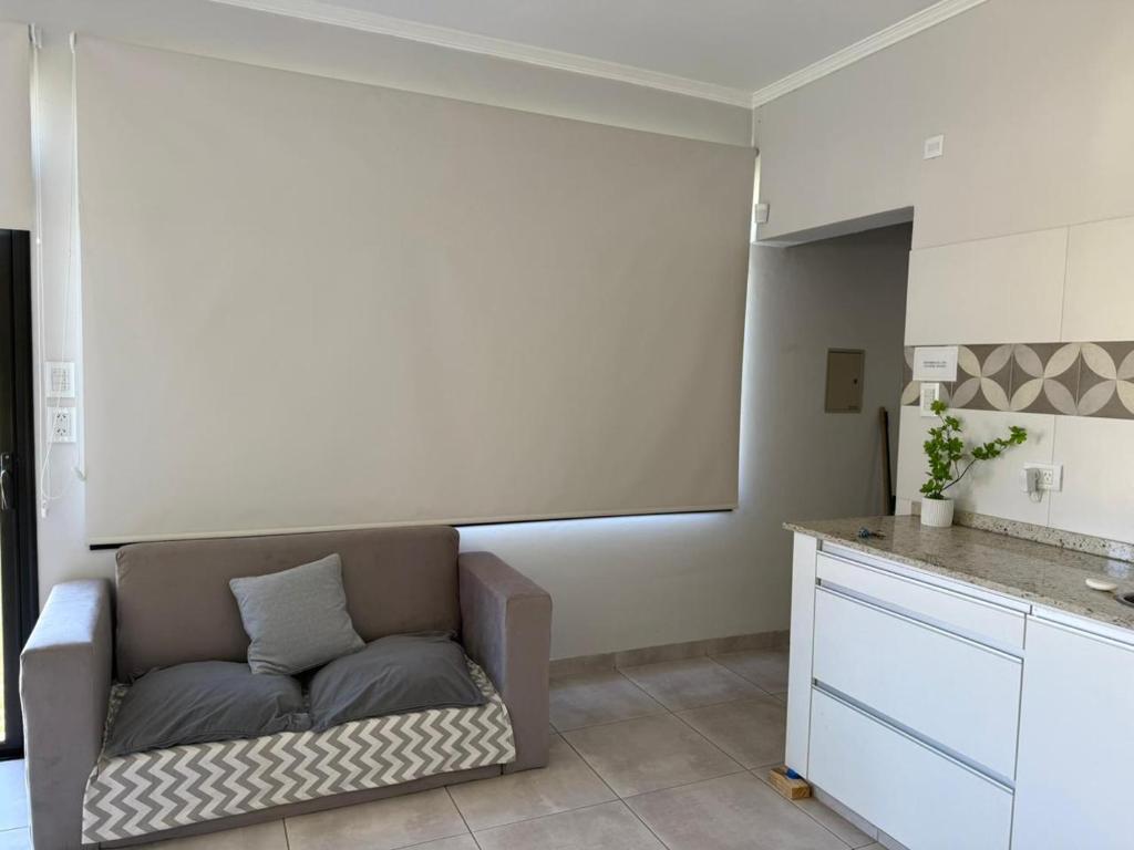 a living room with a couch in a kitchen at Las moras saladillo in Saladillo