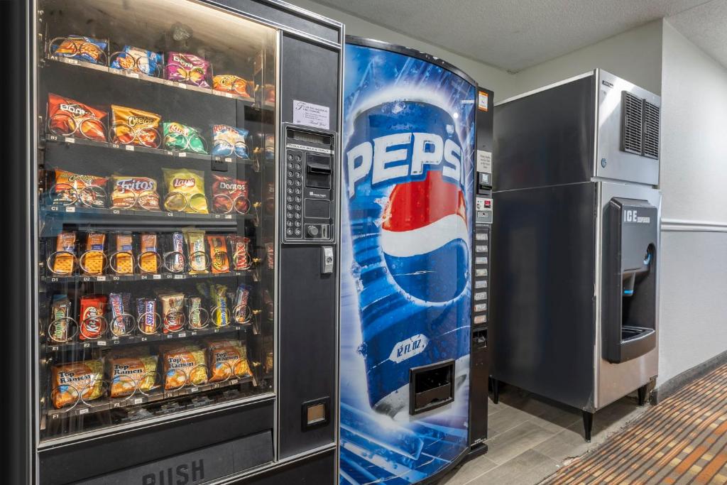 a large pepsi machine in a room with soda at Greenville Pelham Inn by IHG in Greenville