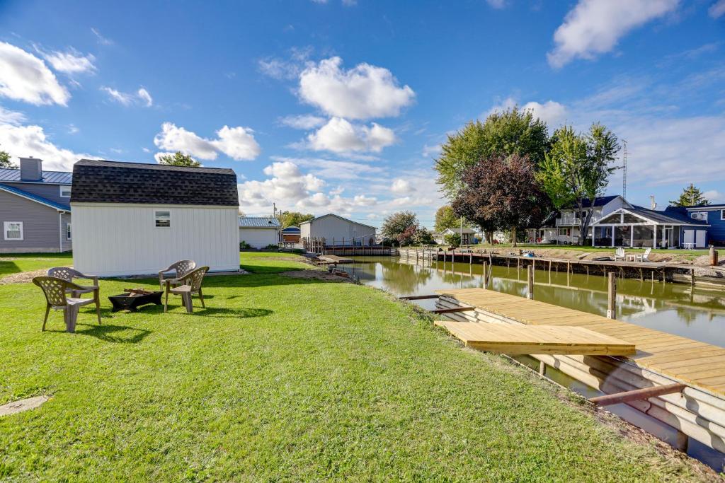 a picnic table and benches next to a body of water at Walk to Lagoon Saloon! Chic Home on Nugents Canal in Lacarne