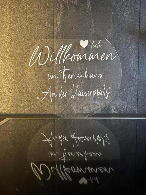 a sign for a restaurant with handwriting on a wall at Ferienhaus an der Kaiserpfalz in Niederdorla
