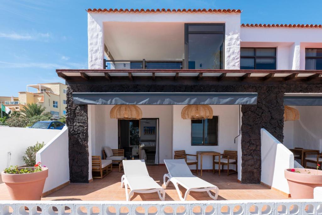 a view from the balcony of a house with chairs and tables at Sand & Beach in Pájara