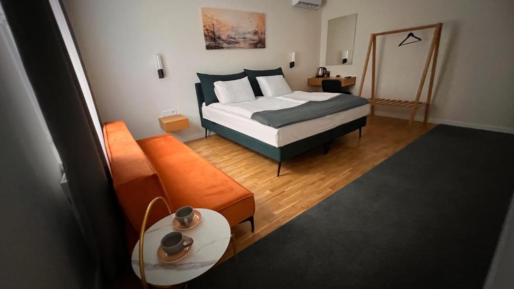 a bedroom with a bed and a couch at Eda7 Boutique Rooms in Sarajevo