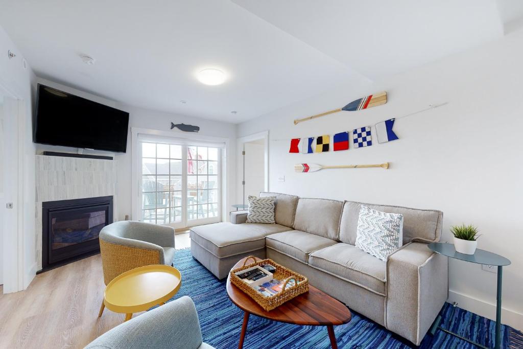 a living room with a couch and a fireplace at Villa Balena - A Cape Cod Oasis in Dennis Port