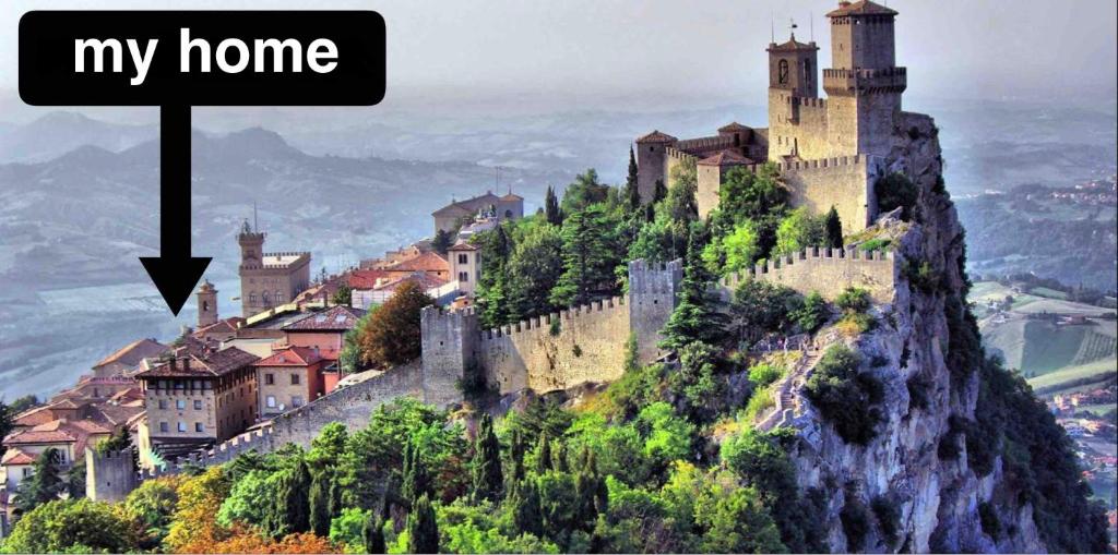 a castle perched on top of a mountain at All'ingresso delle antiche mura della città in San Marino