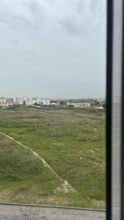a view of a field of grass from a window at Helder&Joana in Soengas