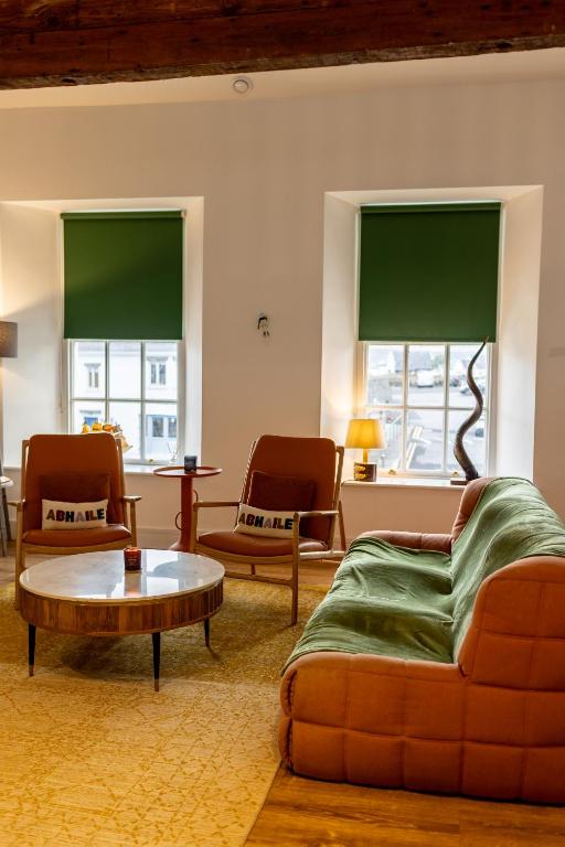 a living room with a couch and a coffee table at Egan's Bar Apartment in Liscannor