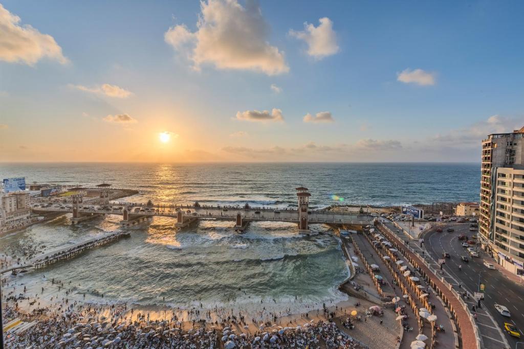 an aerial view of the beach at sunset at Nabeel Homes - Panoramic Seaview Condo in Stanley in Alexandria