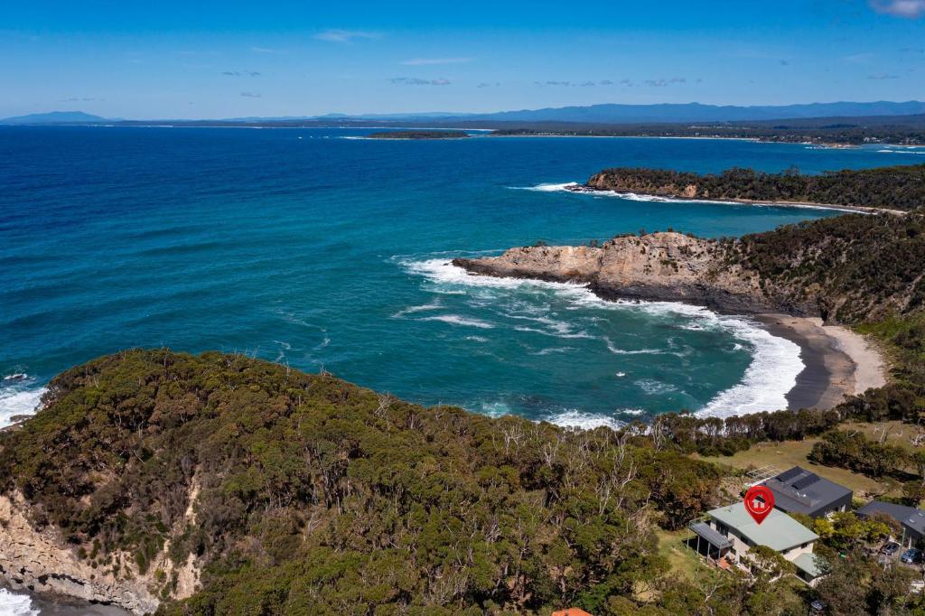 an aerial view of a beach with a stop sign at Kareelah in Tomakin