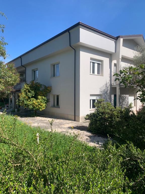 a large white building with a black roof at Il giardino di Silvia in Isernia
