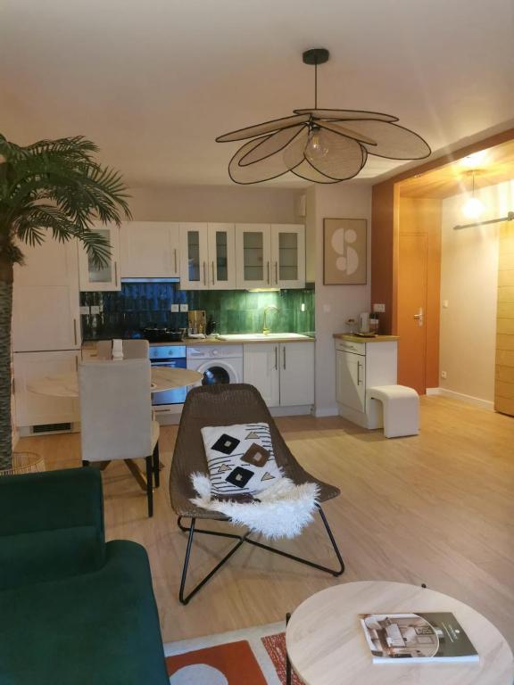 a living room with a couch and a table at Beautiful cocooning appartement in La Chapelle-sur-Erdre