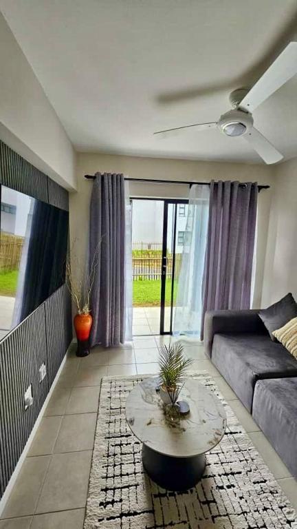 a living room with a couch and a table at Bliss Ballito 2 in Ballito