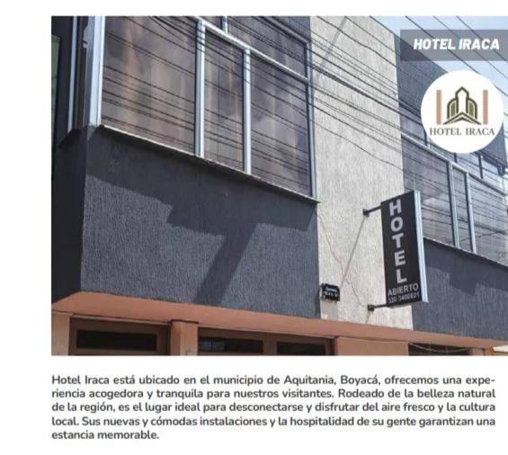 a building with a sign on the side of it at Hotel Iraca in Aquitania