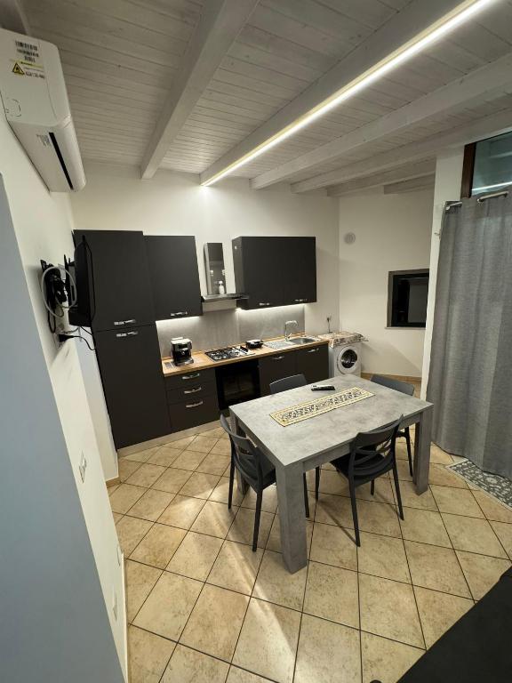 a kitchen with a table and chairs in a room at IL moro in Acireale