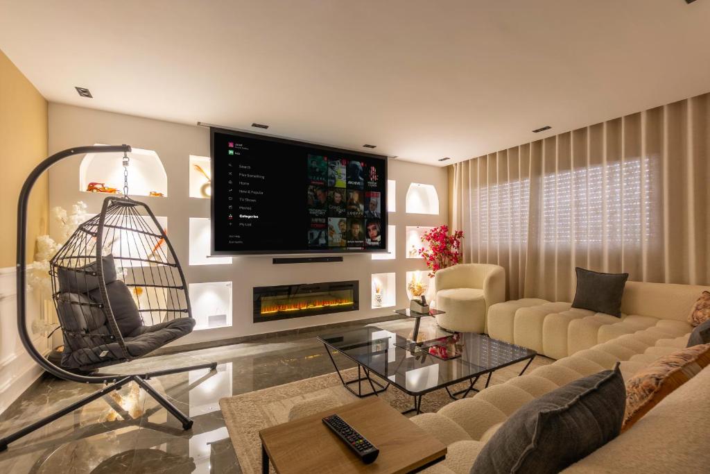 a living room with a couch and a fireplace at Appartement avec salle de cinema in Agadir