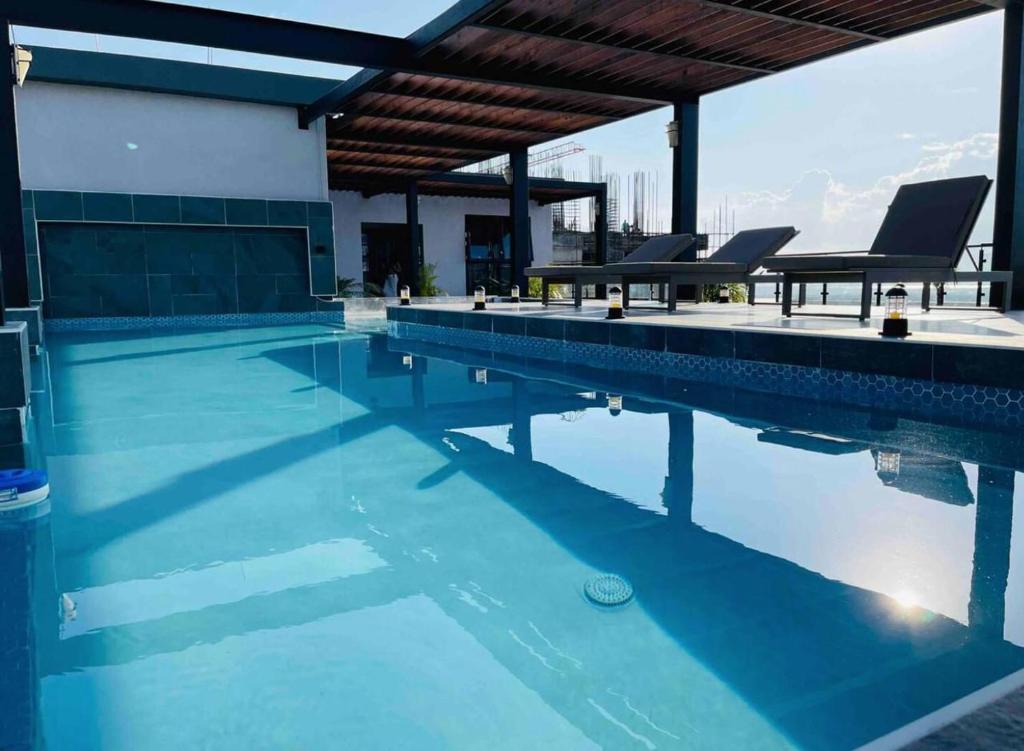 a swimming pool with blue water in a building at Rooftop Pool Condo in Kingston in Kingston