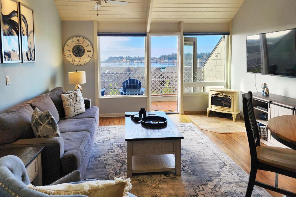 a living room with a couch and a table at Historic Bayfront! Stellar Bridge & Bay Views! Bay Dreaming in Newport