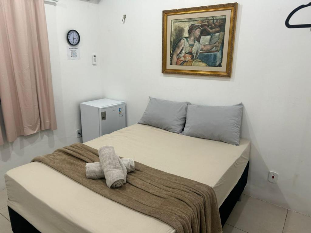 a bedroom with two beds and a picture on the wall at Studio central in Macapá