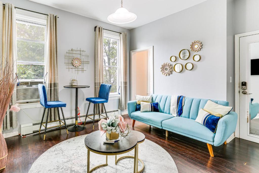 a living room with a blue couch and blue chairs at Explore and Work! Stylish Washington Heights Duplex in Newburgh