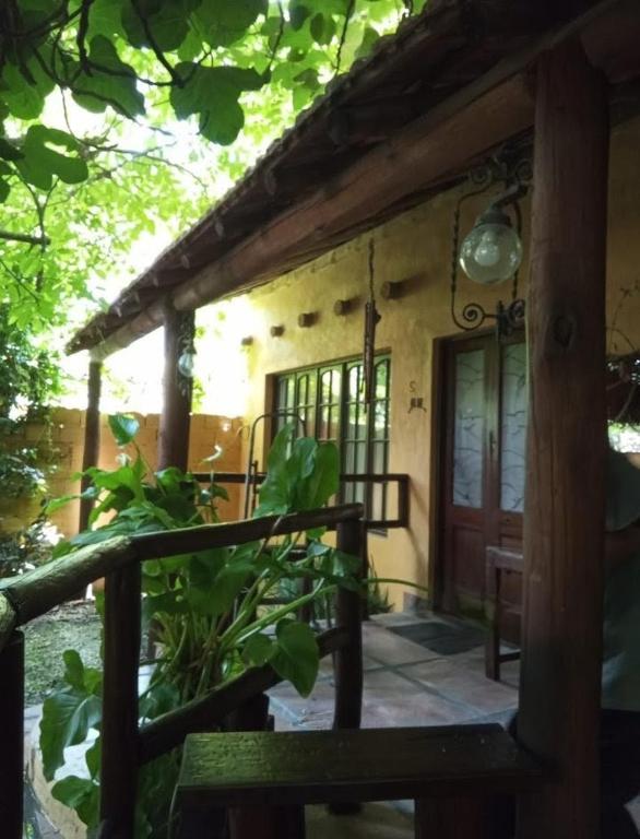a porch of a house with a wooden door at Cabañas La Polaca 2 in Santa Clara del Mar