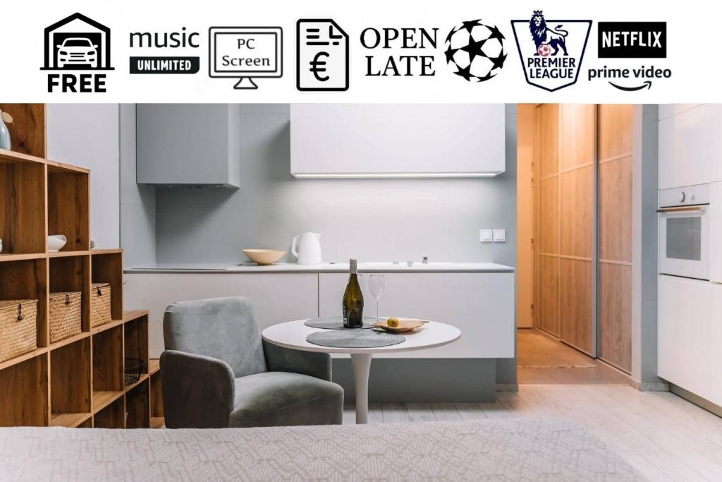 a kitchen with a table and a chair at E3 Luxury OldTown Apt w Free Garage, Supermarket, FastWifi, Unlimited Music, Prime Video, Aircon in Košice