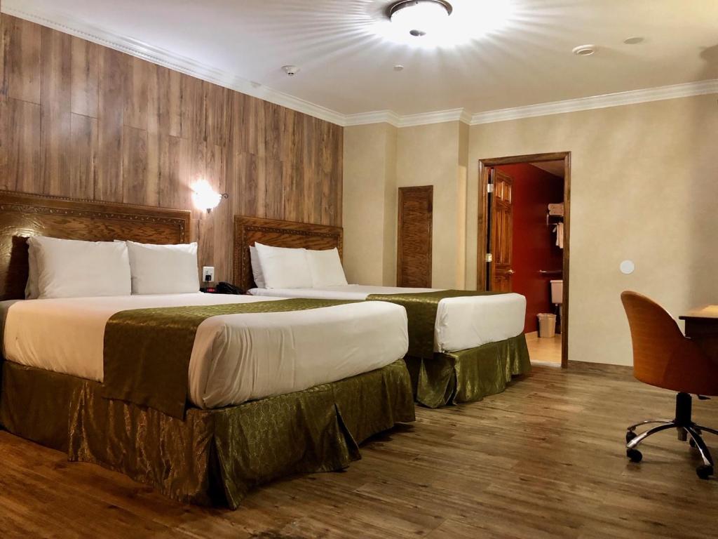 a hotel room with two beds and a desk at The Architect in Washington