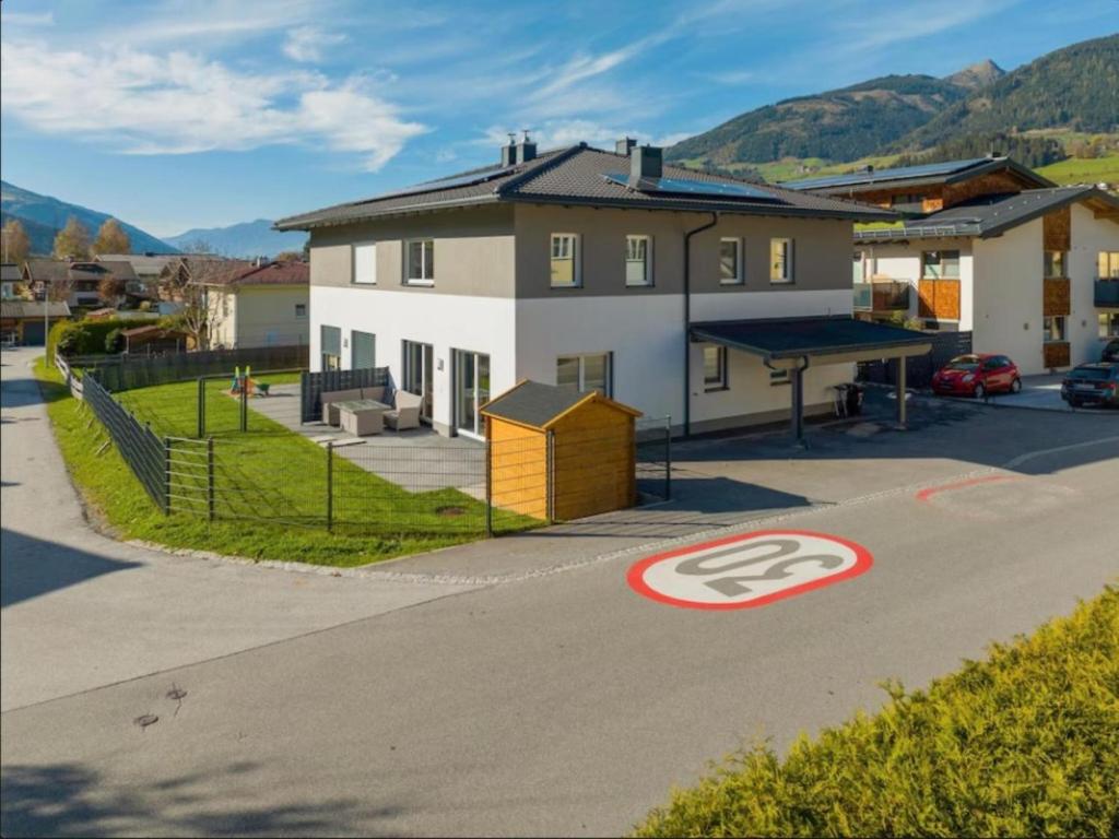 a house with a ping pong table in a parking lot at JooP in Niedernsill