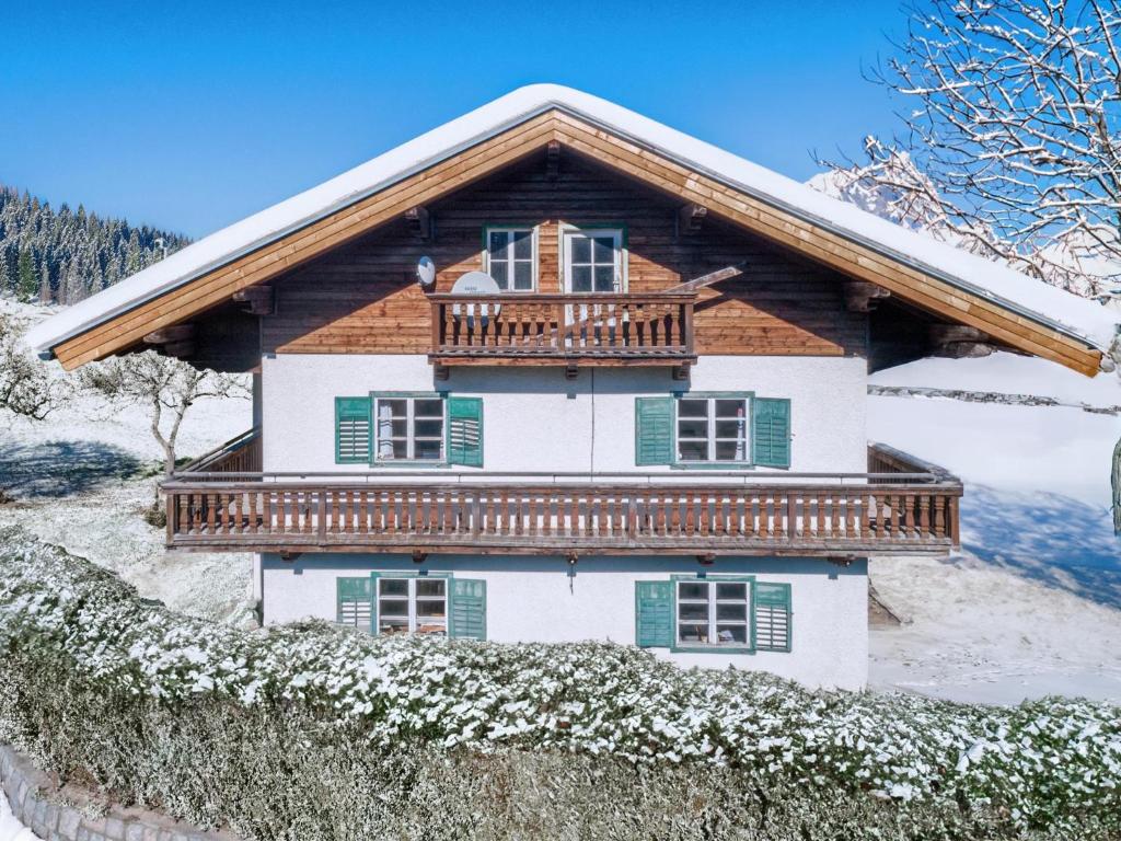 a house with a balcony on top of it at Landhaus Platzl in Hopfgarten im Brixental
